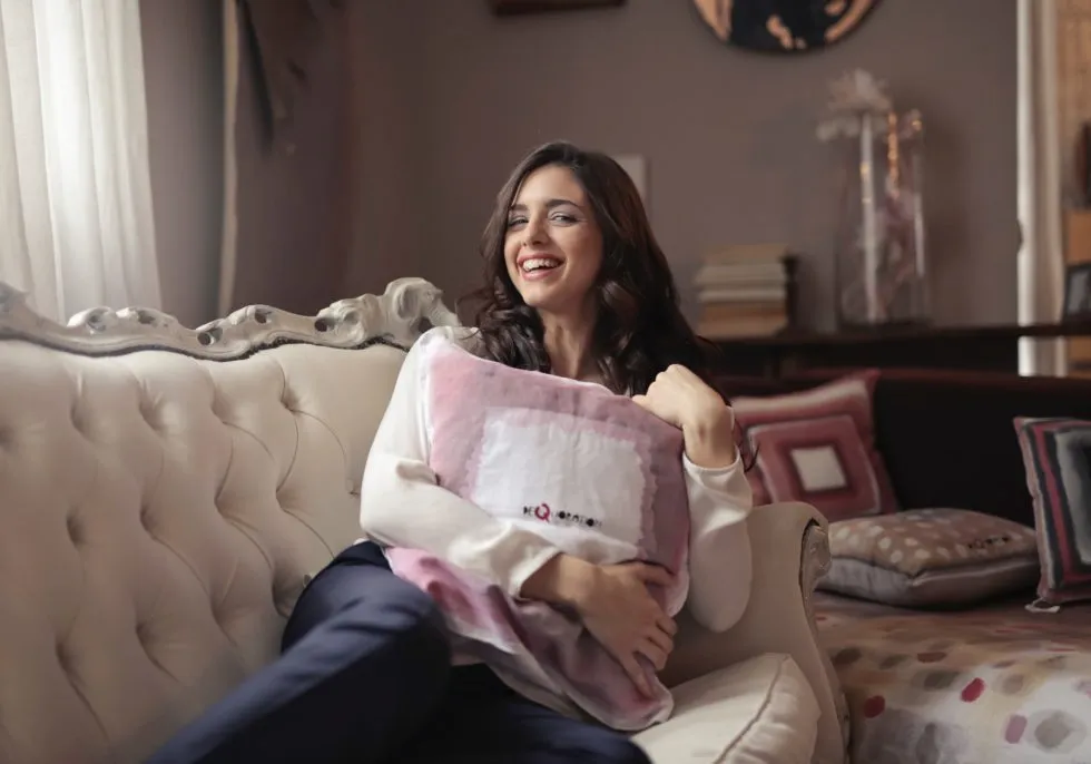 Hormone Treatment for PCOS - woman sitting on couch holding a pillow
