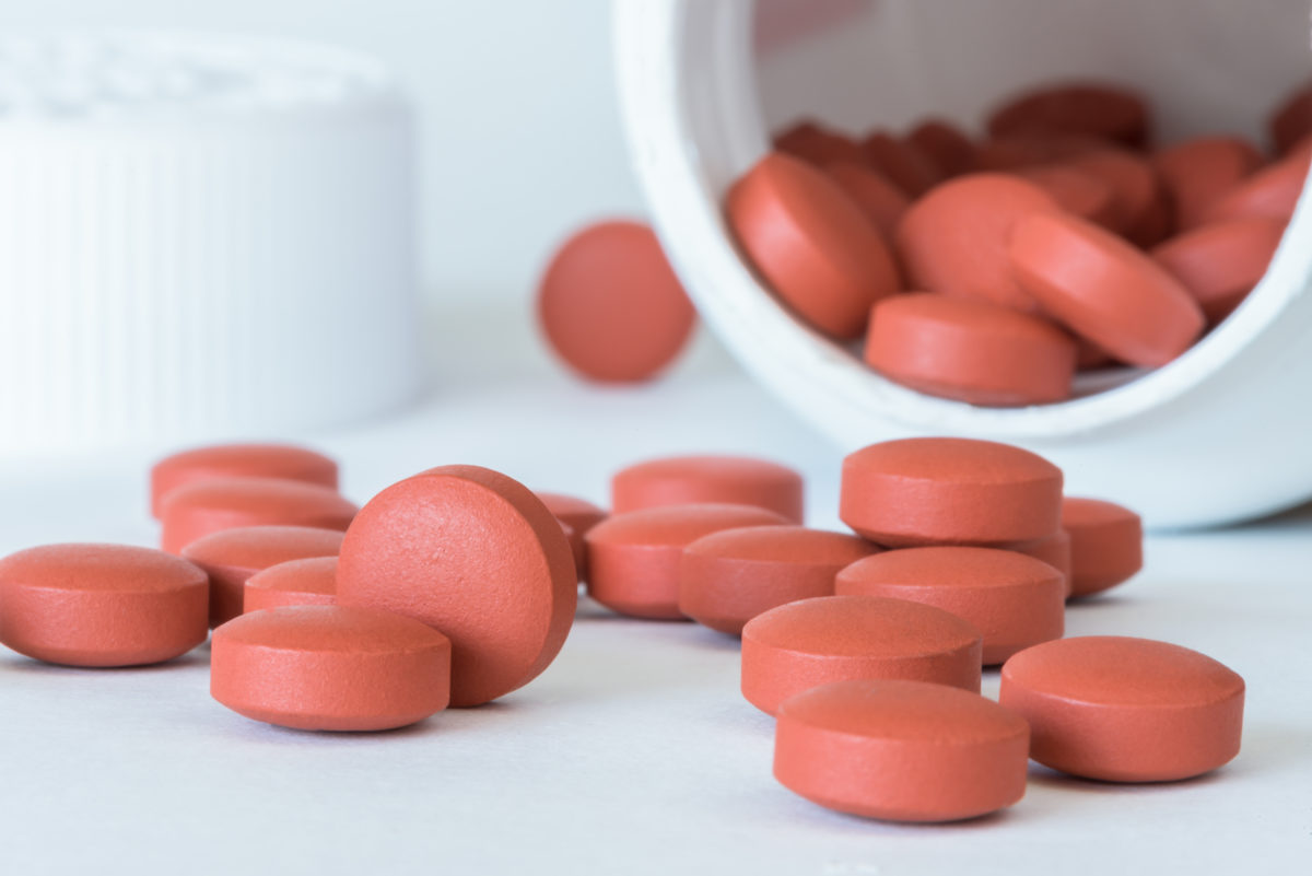 pills spilled on a table from the bottle