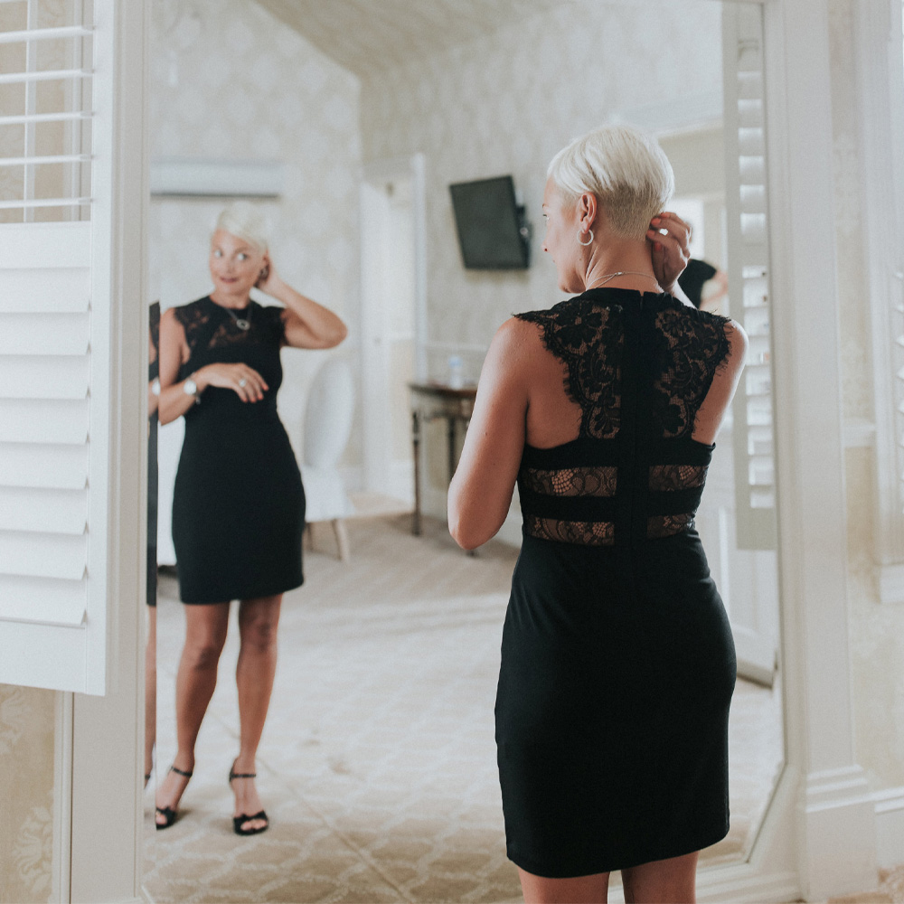 pink blob Woman looks at herself in the mirror