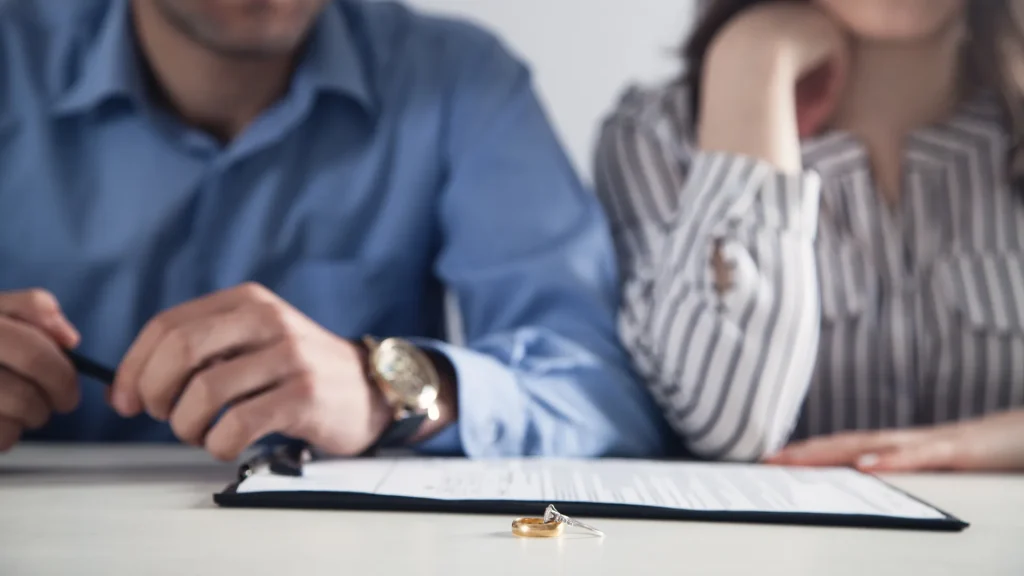 Couple sitting at a table filing for divorce